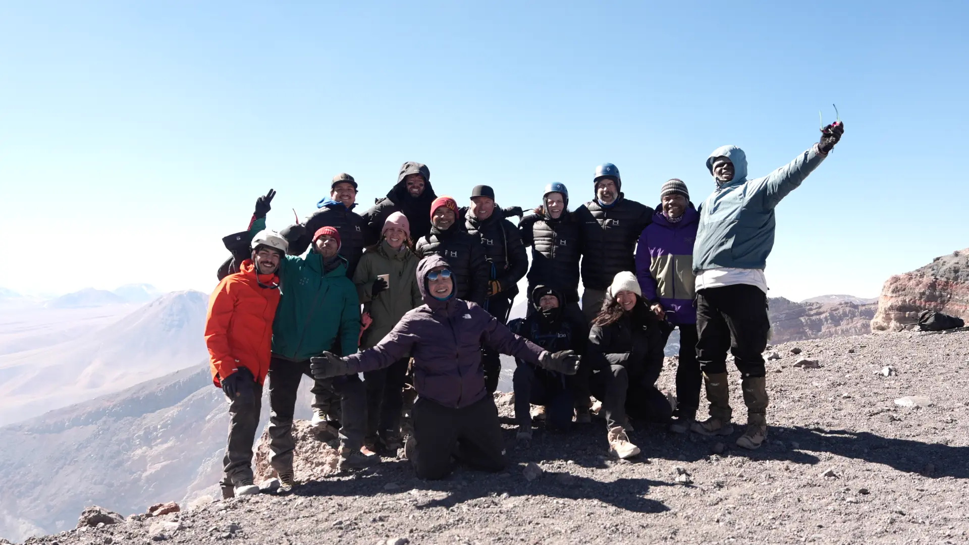 The full No Matter What group celebrating together on a summit