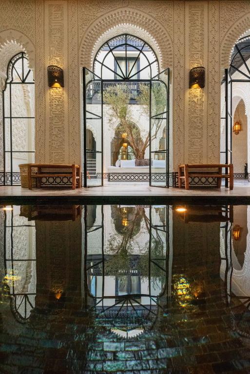 Ornate arched interior and reflecting pool at Riad Kheirredine