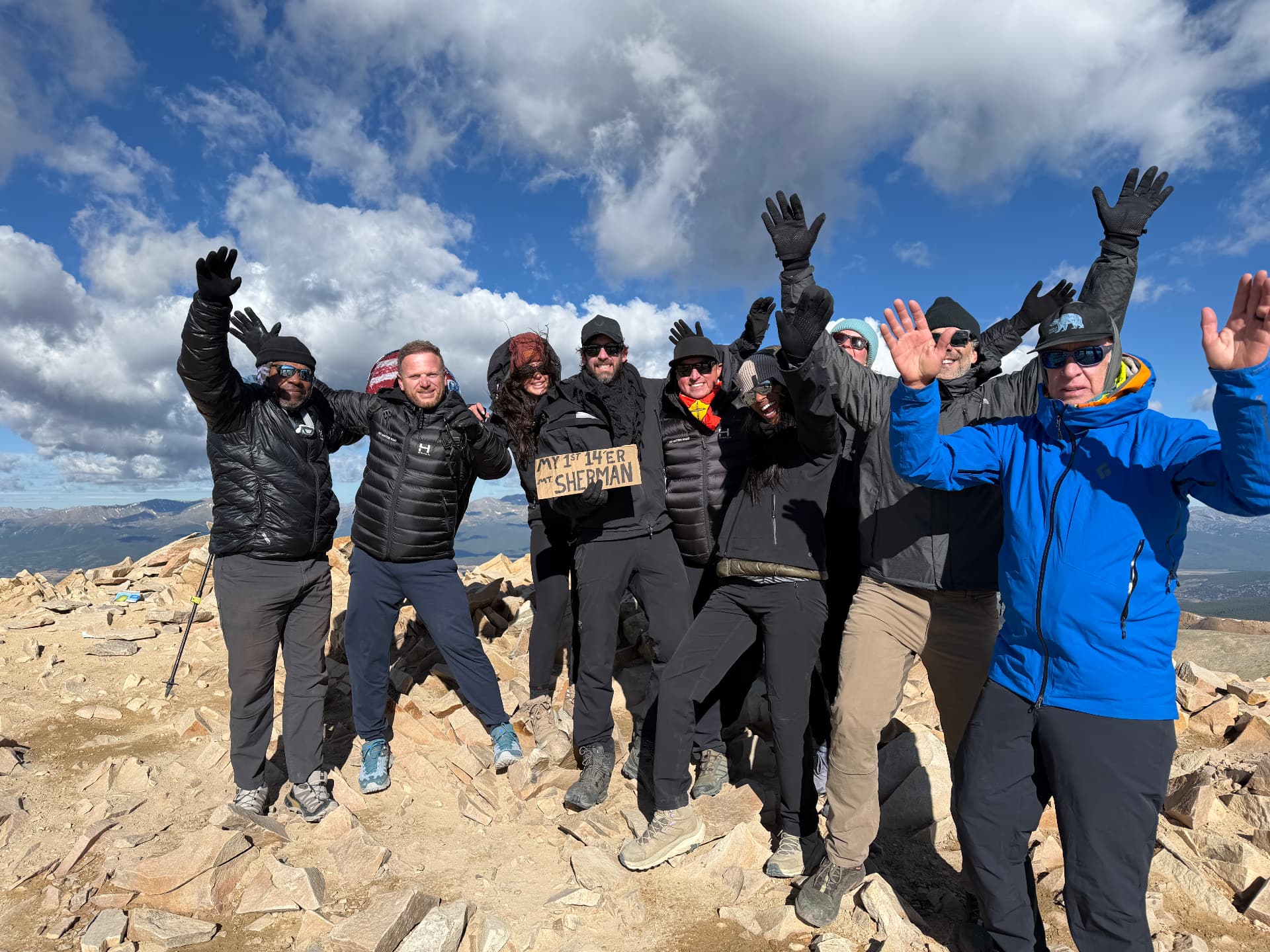 The team celebrating together on the summit of Mt Sherman