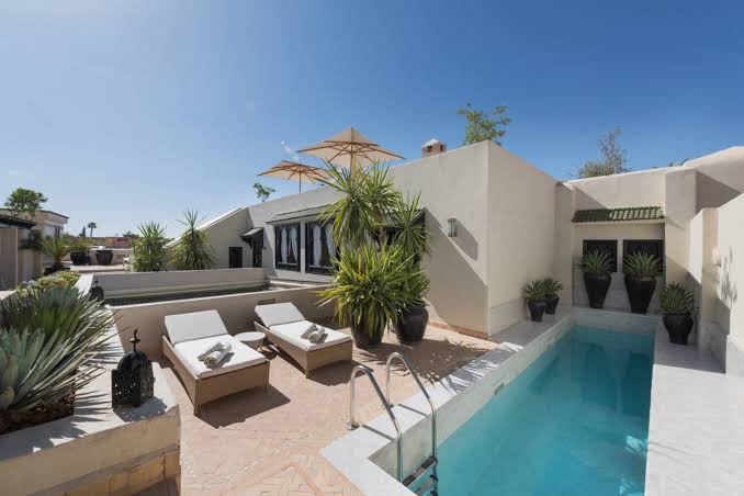 Sunny rooftop plunge pool and terrace at Riad Kheirredine